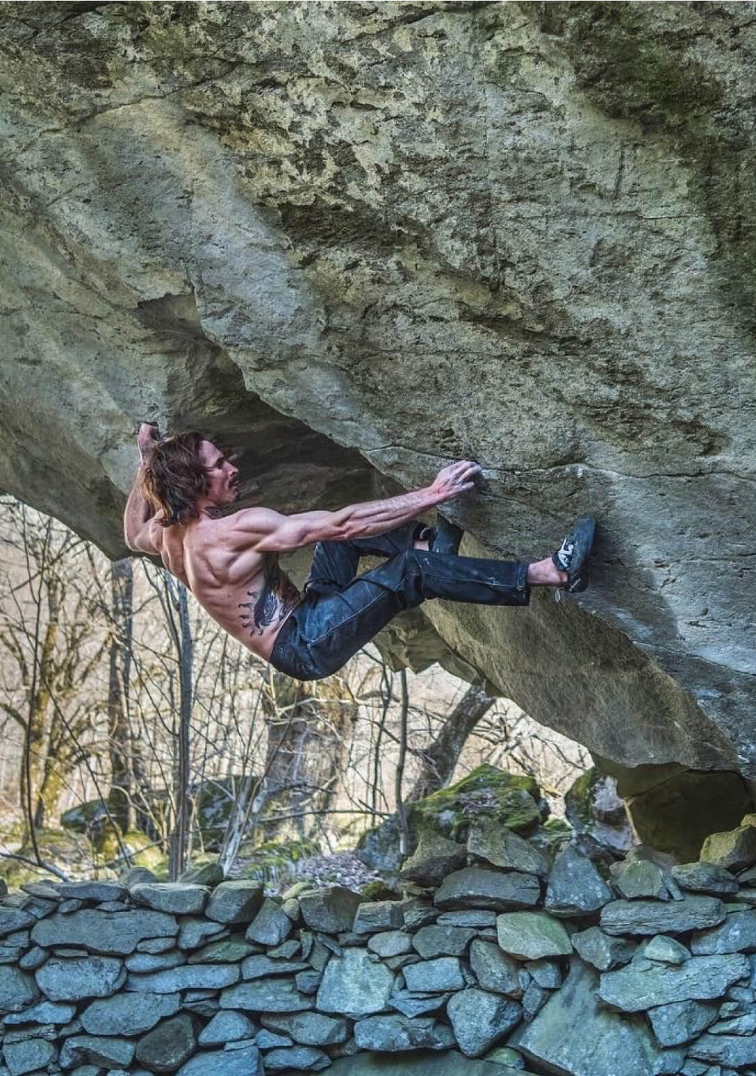 Climbers on dramatic rock face at golden hour